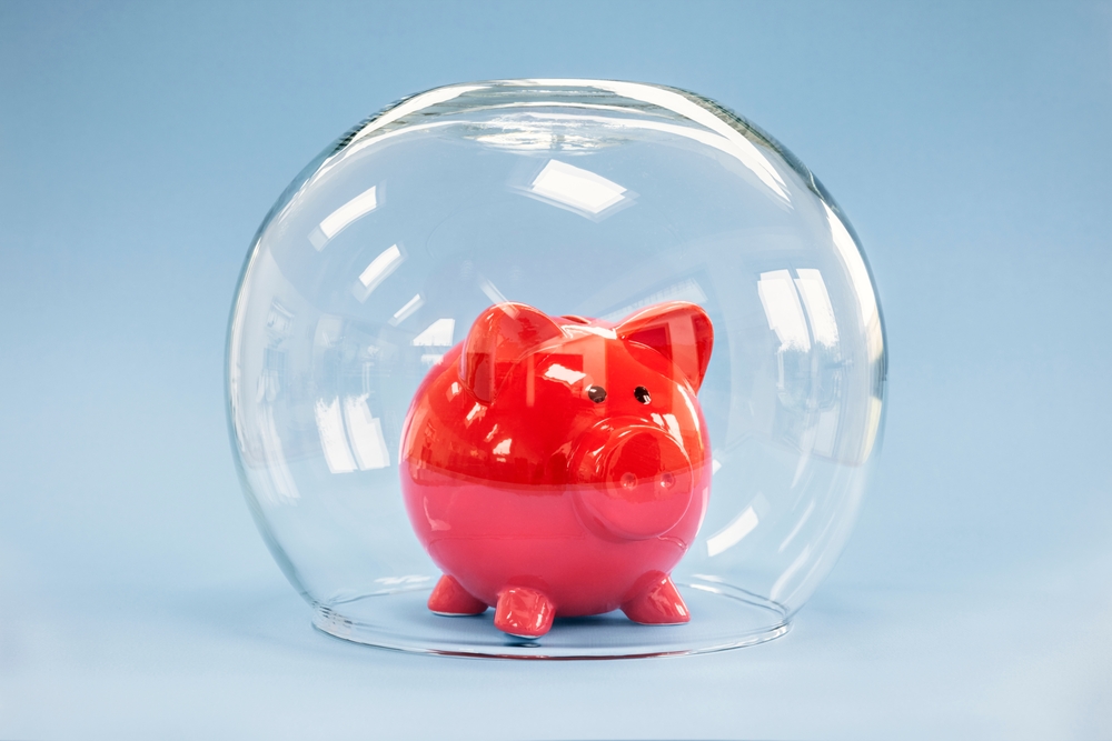 prenuptial agreements keeps money safe, shows by red piggy bank surrounded by glass bowl